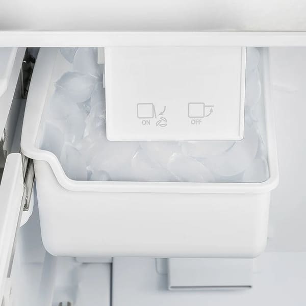 Close-up view of the built-in ice maker inside the Forno 30-inch French door refrigerator in stainless steel, featuring a compact, automatic design for convenient ice production and storage within the freezer drawer.