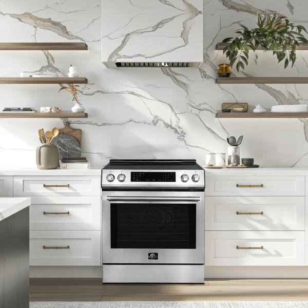 Lifestyle view of the FORNO 30-inch induction range in stainless steel, stylishly built into a contemporary kitchen with coordinated cabinetry, backsplash, and countertop decor.
