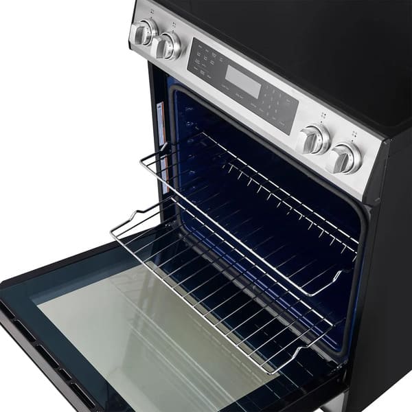 Interior view of the FORNO 30-inch induction range in stainless steel, showing multiple oven racks and spacious cooking capacity.