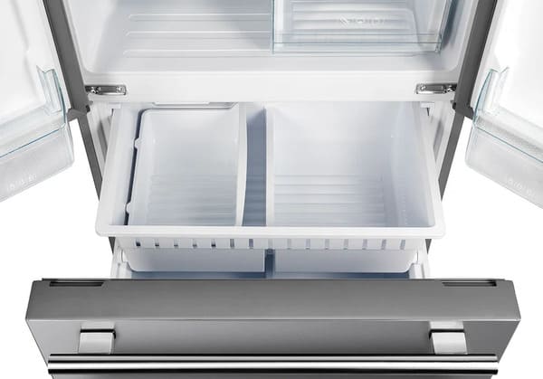 Open view of the bottom freezer drawer in the FORNO 30-inch French door refrigerator in stainless steel, revealing spacious freezer compartments for organized frozen food storage.