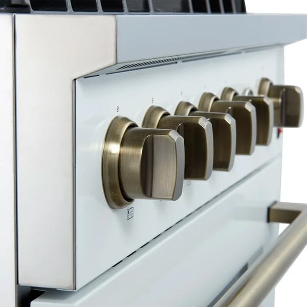 Close-up view of the control knobs on the FORNO Giovanni 30-Inch Gas Range in white, highlighting stainless steel finishes, precision temperature markings, and a clean matte white panel design.