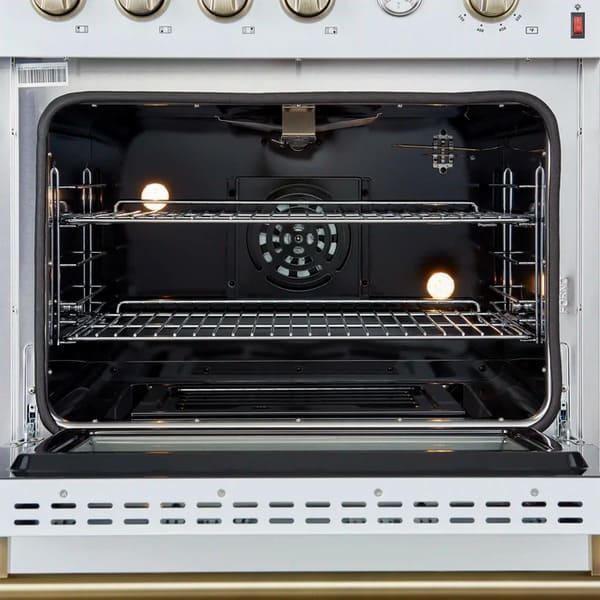 Interior view of the FORNO Marco 30-Inch Gas Range in white, highlighting the vibrant blue enamel oven cavity, convection fan, and chrome racks designed for even heat distribution and flexible cooking.