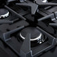 Close-up view of a brass burner on the Forno Antico 36-Inch Dual Fuel Range, highlighting premium construction, precise flame control, and heavy-duty cast iron grates.