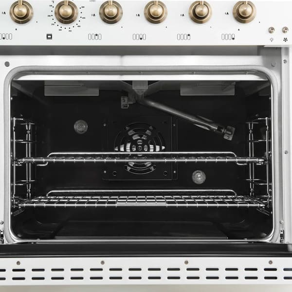 Interior view of the main oven in the Forno Antico 48-Inch Gas Range in white, featuring a vibrant blue enamel cavity, convection fan, and multi-level heavy-duty oven racks for versatile baking and roasting.