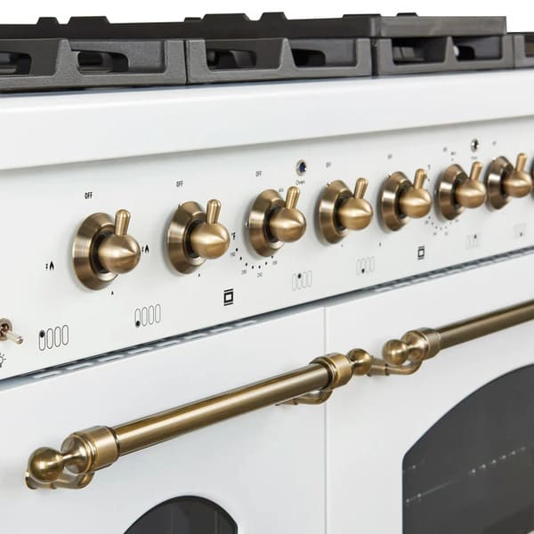 Close-up of the control knobs on the Forno Antico 48-Inch Gas Range in white, featuring polished brass bezels, stainless steel construction, and precision markings for accurate temperature control.