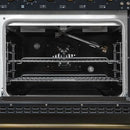 Interior view of the main oven in the Forno Antico 48-Inch Gas Range, showcasing a vibrant blue enamel cavity, convection fan, and multi-level heavy-duty oven racks for versatile cooking.